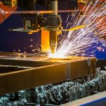 A closeup shot of sparks flying from an industrial steel cutter